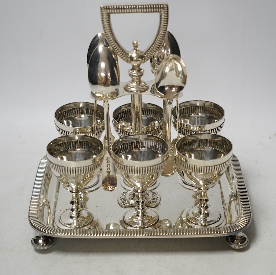 A silver plated six setting egg cruet, 19cm high. Condition - good